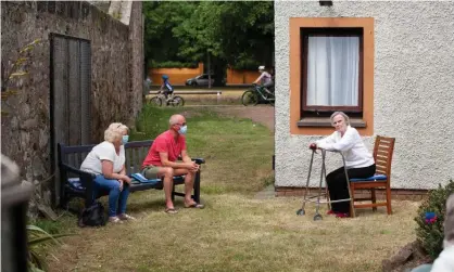  ??  ?? A socially distanced family visit in the garden of Eskgreen care home in Musselburg­h, East Lothian. Photograph: Murdo MacLeod/The Guardian