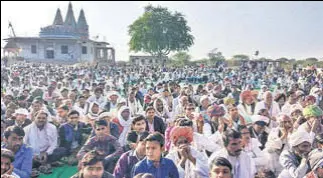  ??  ?? Members of the Gujjar community stage a sit-in at the rail tracks in Rajasthan’s Swai Madhopur on Friday.pti