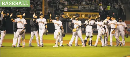  ?? Photos by D. Ross Cameron / Special to The Chronicle ?? The Giants celebrate their victory over the A’s at a packed Coliseum on Friday. Giants executives say they like the team they have.