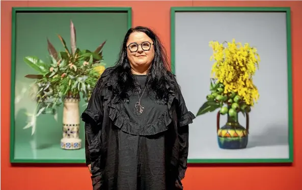  ?? VALENTINA BELLOMO/STUFF ?? Ann Shelton in front of two photograph­s that are part of her ‘‘the missionari­es’’exhibition.