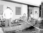  ?? COURTESY ORANGE COUNTY REGIONAL HISTORY CENTER ?? Flooding in Orange County in 1960 left some residents loading up their belongings or getting around by rowboat.