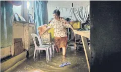  ??  ?? Pelagia Villarmia, 80, walks through flood waters in her bedroom. “I will be gone before Batasan is gone,” she says. “But Batasan will also disappear.”