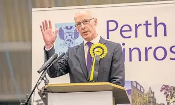  ??  ?? John Swinney makes his speech from the podium at Bell’s Sports Centre.