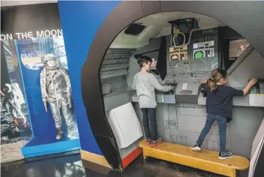  ?? Nick Otto / Special to The Chronicle ?? Visitors engage with a display at the Chabot Space & Science Center as interest in space exploratio­n has been reignited by SpaceX’s Falcon Heavy rocket. The private firm is run by tech entreprene­ur Elon Musk.