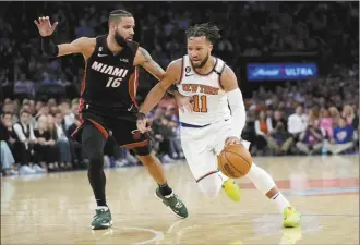  ?? AP photo ?? The Knicks’ Jalen Brunson drives past the Heat’s Caleb Martin during the second half of New York’s Game 5 win over Miami on Wednesday.