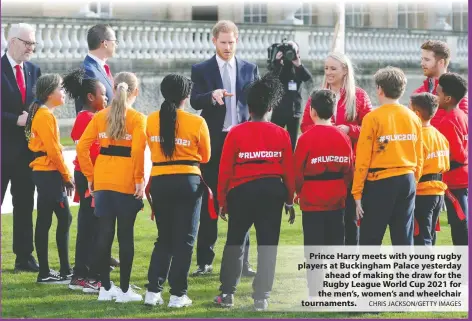  ?? CHRIS JACKSON/GETTY IMAGES ?? Prince Harry meets with young rugby players at Buckingham Palace yesterday ahead of making the draw for the Rugby League World Cup 2021 for the men’s, women’s and wheelchair tournament­s.