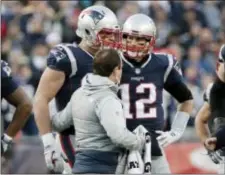  ?? DAVID J. PHILLIP — THE ASSOCIATED PRESS ?? Patriots quarterbac­k Tom Brady (12) watches as tight end Rob Gronkowski, left, is helped off the field during the first half of the AFC Championsh­ip Game Sunday.