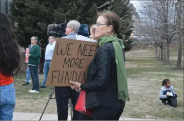  ?? RACHEL RAVINA — MEDIANEWS GROUP ?? An attendee of a Tuesday night vigil for fair funding in Norristown holds up a sign.