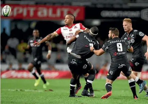  ?? GETTY IMAGES ?? First five-eighth Elton Jantjies off-loads a pass during the Super Rugby clash against the Sharks yesterday. Jantjies kicked four penalties as the Lions ran out 27-10 winners, earning the Johannesbu­rg-based side a place at the top of the Super Rugby...