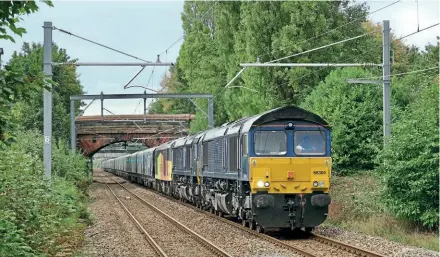  ?? Doug Birmingham ?? On September 24, Nos. 66304+66305 (+60056 dead in train) power the 6E17 12.58 Liverpool-Drax loaded biomass towards Whiston station. This was the first freight working under GBRf ownership for former DRS locos Nos. 66304 and 66305.