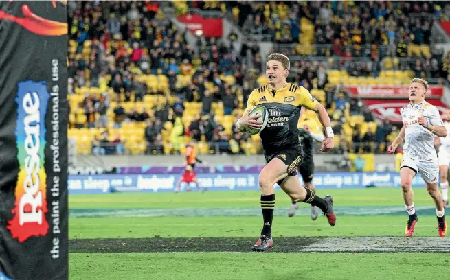  ?? PHOTO: PHOTOSPORT ?? Final here we come: Hurricanes playmaker Beauden Barrett even has time to look at the big screen before dotting down for his try in the Super Rugby semifinal win over the Chiefs on Saturday.