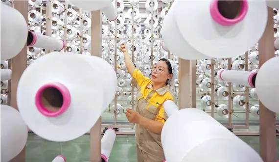  ?? ?? A production scene at an enterprise in Suqian City, east China’s Jiangsu Province. — CFP