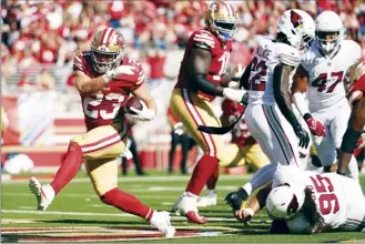  ?? AP photo ?? Niners running back Christian McCaffrey scores a touchdown in the second half of San Francisco’s 35-16 win over the Arizona Cardinals on Sunday.
