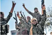  ??  ?? Kurdish soldiers, top, wave their yellow flags after pulling down Isil’s black banners; SDF fighters, above, celebrate victory