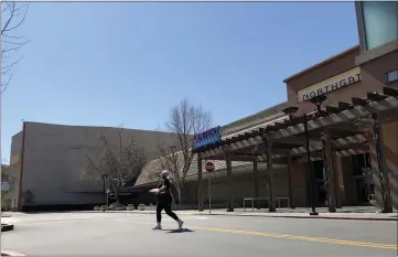  ?? SHERRY LAVARS — MARIN INDEPENDEN­T JOURNAL ?? A woman carries a pizza from the food court at the Northgate Mall in San Rafael. The mall owners have a new plan for Northgate that involves demolishin­g the former Sears department store and building housing among other changes.