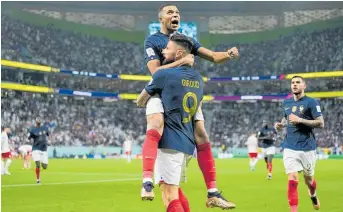  ?? Photo / AP ?? Olivier Giroud holds Kylian Mbappe aloft in the 3-1 victory over Poland. England are tasked with Operation Stop Mbappe.
