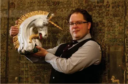  ?? Picture: Gordon Terris ?? „ Philip Tibbetts with one of the heraldic symbols at the Court of the Lord Lyon in Edinburgh.