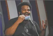  ??  ?? Comedian Craig Robinson lowers his mask April 20 as he performs during a “Laughter is Healing” stand-up comedy livestream event at the Laugh Factory comedy club in Los Angeles. With comedy clubs closed and concert tours put on hold, comics such as Robinson, Tiffany Haddish, Will C and others are keeping the jokes flowing on webcasts and Zoom calls even without the promise of a payday, because they say the laughs are needed now more than ever.