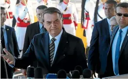  ?? AP ?? Brazil’s President Jair Bolsonaro, centre, said Brazil will only accept an offer of internatio­nal aid to fight Amazon fires if French leader Emmanuel Macron retracts comments that he finds offensive.