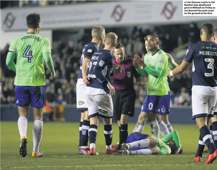  ??  ?? > Loic Damour reacts to Sol Bamba’s late disallowed goal at Millwall on Friday as Joe Bennett lies pole-axed on the ground at the Den