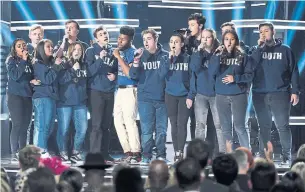  ?? CHRIS PIZZELLO/INVISION/THE ASSOCIATED PRESS ?? Khalid, seventh from left, and Shawn Mendes, fifth from right, perform “Youth” with the Marjory Stoneman Douglas High School show choir from Parkland, Fla., at Sunday’s Billboard Awards.