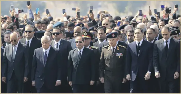  ?? AFP ?? Egyptian President Abdel Fattah El Sisi, centre, and the sons of Egypt’s former president Hosni Mubarak, Alaa, second right, and Gamal, far right, attend Mubarak’s funeral ceremony at Cairo’s Mosheer Tantawy mosque in the eastern outskirts of the Egyptian capital yesterday.