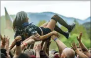  ?? PAUL A. HEBERT—THE ASSOCIATED PRESS ?? In this Oct. 25, 2015 file photo, a festival-goer crowd surfs at the 2015 Knotfest USA in San Bernardino, Calif. Fans and artists are asking the live music industry to make cultural changes to address sexual harassment and groping in the wake of the #MeToo movement. Festivals are responding by training festival staff and volunteers on how to respond to harassment, adding booths or signs with informatio­n on where to report sexual violence and having clearly posted anti-harassment policies.