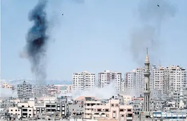  ?? AFP ?? Smoke billows in the background following an Israeli air strike on Hamas militants in the Gaza Strip yesterday.