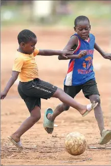  ?? AP ?? Two boys play soccer at an open space in Harare, Zimbabwe, on Nov 13. Africa is represente­d at the FIFA World Cup in Qatar by Senegal, Tunisia, Morocco, Cameroon and Ghana.