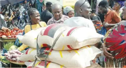  ?? ?? Christmas is by here again and the movement of food items, such as rice is unstoppabl­e, even where the roads seem inaccessib­le IMAGE by Pius Okeosisi