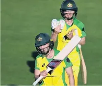  ?? PHOTO: GETTY IMAGES ?? Job done . . . Meg Lanning (front) and Nicola Carey walk off the field after Australia’s win in the second oneday internatio­nal against New Zealand in Brisbane yesterday.