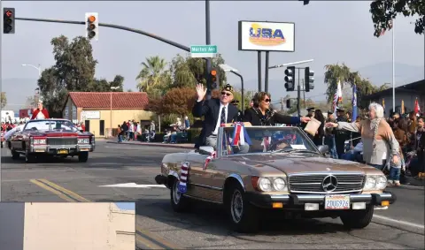  ?? PHOTO FOR THE RECORDER BY JAMIE A. HUNT ?? Veterans Parade Grand Marshal Brian Adams and his wife Rebecca Adams ride in a vintage Mercedes coupe during the Veterans Day Parade on Thursday, November 11, 2021.