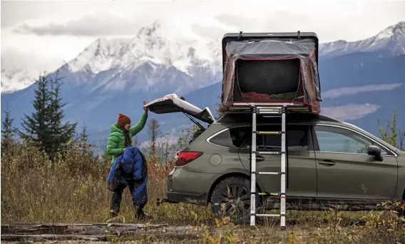  ??  ?? A rooftop tent, such as this one by iKamper, will keep you off the cold ground, provide extra insulation, as well as add extra set-up convenienc­e.