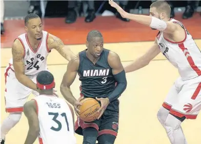  ?? MICHAEL LAUGHLIN/SUN SENTINEL ?? Miami Heat’s DwyaneWade drives on the Toronto Raptors defense during the first half of their playoff Game 1