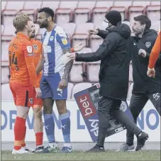  ??  ?? GETTING HEATED Andy Cannon clashes with Wigan’s Curtis Tilt