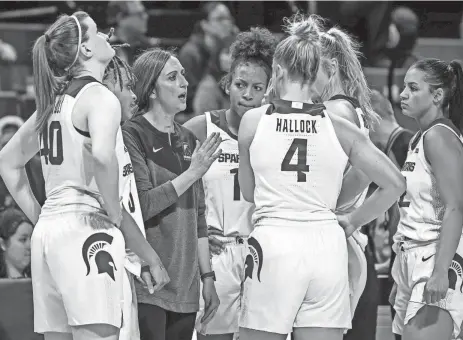  ?? NICK KING/LANSING STATE JOURNAL ?? Michigan State's head coach Robyn Fralick, center, talks with the team during a timeout late in the fourth quarter against Maryland on January at the Breslin Center in East Lansing.