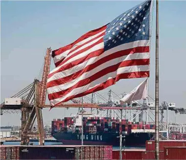  ?? Foto: AFP ?? Die Us-flagge weht über einem chinesisch­en Containers­chiff in einem kalifornis­chen Hafen.
