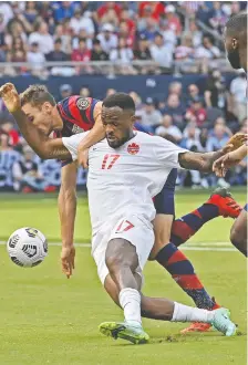  ?? PETER AIKEN/GETTY IMAGES ?? Canada's Cyle Larin battles James Sands of the U.S. during Sunday's CONCACAF Gold Cup match in Kansas City.