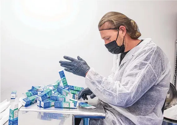  ?? ROBERTO E. ROSALES/JOURNAL ?? Glenn Weinstein, head of packaging at Panaxia, gets boxes prepped for medical cannabis tinctures. Panaxia, based in Israel, has a partnershi­p with Ultra Health and manufactur­es its edibles at the cannabis company’s facility in Bernalillo.