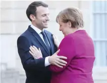  ??  ?? French President Emmanuel Macron welcomes German Chancellor Angela Merkel at the Elysee Palace in Paris on Friday. (AFP)