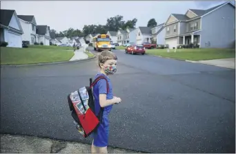  ?? BRYNN ANDERSON — THE ASSOCIATED PRESS ?? Paul Adamus, 7, waits at the bus stop for the first day of school on Monday in Dallas, Ga.