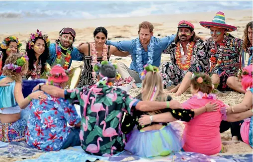  ?? AP ?? Prince Harry and Meghan, Duchess of Sussex, meet a surfing community group, known as Onewave, in a fun and engaging way at Bondi Beach in Sydney yesterday.