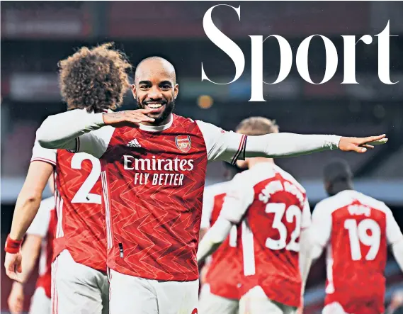  ??  ?? Spot on: Alexandre Lacazette celebrates scoring the wnning penalty in Arsenal’s 2-1 victory over north London rivals Tottenham at the Emirates, after a foul on him by Davinson Sanchez
