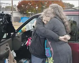  ?? Gina Ferazzi Los Angeles Times ?? LONGTIME FRIENDS Tamara “Tammy” Smith, left, and Kellie Wilkerson are reunited in Butte County, Calif. Smith was left homeless by the Camp fire.