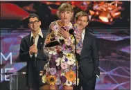  ??  ?? Taylor Swift accepts the award for album of the year for “folklore” at Sunday’s 63rd annual Grammy Awards at the Los Angeles Convention Center. Swift became the fourth artist and first woman to receive the album award three times. (AP/Chris Pizzello)