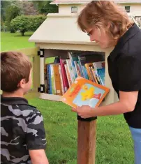  ??  ?? Charlotte Endorf often helps visiting kids like Sam (above) find the perfect book.