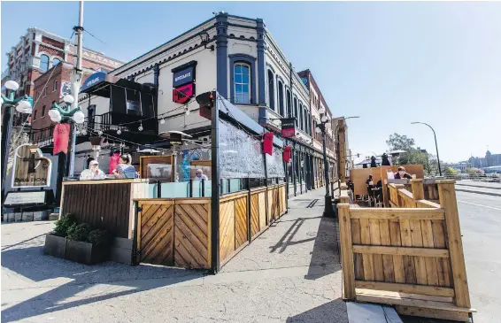  ?? DARREN STONE, TIMES COLONIST ?? The City of Victoria will expand the Build Back Victoria program, which allowed businesses, like Darcy’s Pub on Wharf Street, to expand onto sidewalks, streets and boulevards.