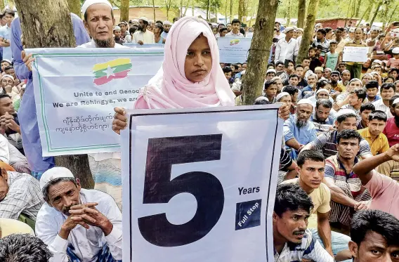  ?? PHOTO: REUTERS ?? Protesters . . . Rohingya refugees hold placards as they gather at the Kutupalong Refugee Camp, in Cox’s Bazar, Bangladesh, to mark the fifth anniversar­y of their fleeing from neighbouri­ng Myanmar to escape a military crackdown.