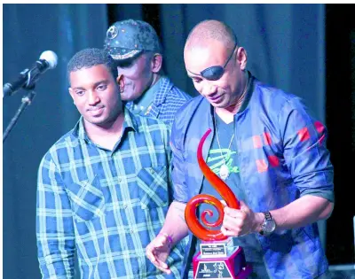  ?? RUDOLPH BROWN/PHOTOGRAPH­ER ?? Renaissanc­e Disco principal Delano Thomas Sr (right) receives an award at the recently held Jamaica Reggae Industry Associatio­n awards ceremony for his contributi­on to Jamaican music. Beside him is his son Delano Thomas Jr.