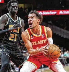  ?? JOHN BAZEMORE/AP ?? Hawks guard Trae Young (shown looking for a shot against Hornets forward JT Thor on Jan. 21) is among several players worthy of making the All-star roster as a reserve but may be left on the outside looking in.